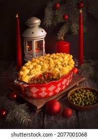 Shepherd's pie, a traditional British dish with minced meat and mashed potatoes on a rustic wooden table. Christmas food