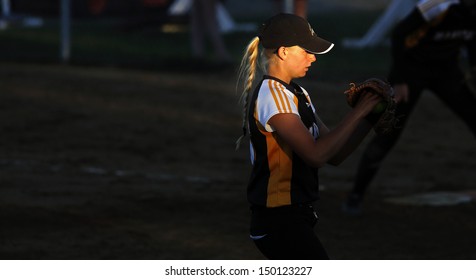 SHERBROOKE, CANADA - August 5: Manitoba's Regan Lawrence Is Spotlighted By The Setting Sun In Women's Softball At The Canada Games August 5, 2013 In Sherbrooke, Canada.