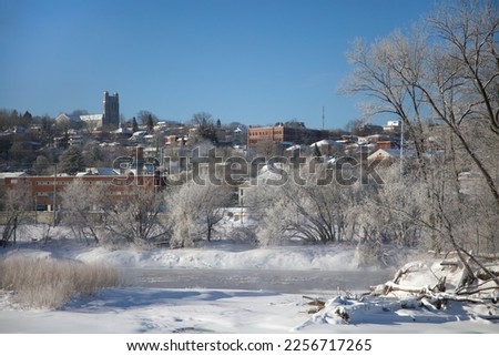 Sherbrooke city downtown in Quebec, river winter landscape frozen ice and snow mist over water cold temperature in Canada
