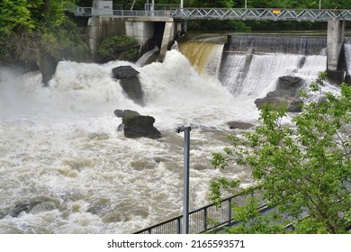 SHERBROOKE, QUEBEC, CANADA - MAY 6, 2022 - Magog River Sherbrooke Abenakis Hydroelectric Power Plant Dam. Water Rushing Down The River In Spring Season.