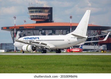 Sheremetyevo International Airport, Moscow, Russia - 06.14.2021. Passenger Aircraft Boeing 737-700 Of Armenia Airlines Lands On The Airport Runway. Airport Terminal And ATC Tower In The Background.