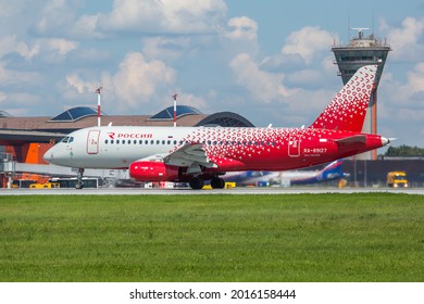 Sheremetyevo International Airport, Moscow, Russia - 06.14.2021. Passenger Aircraft Sukhoi Superjet 100 (SSJ100) Of Rossiya Airlines Takes Off From The Airport Runway. ATC Tower In The Background.