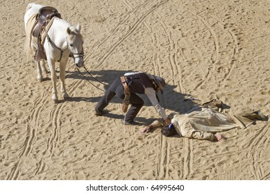 Sheriff Checking A Shot Bandit