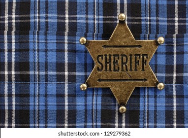 Sheriff Star Badge Attached On Blue Plaid Cowboy Shirt