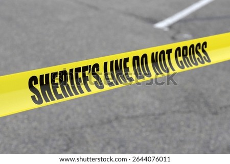 SHERIFF'S LINE DO NOT CROSS. Crime Scene blocked off by law enforcement. Do not cross tape. Part of a Parking Lot closed off for Police and Sheriff Cars and Vans to park and process bad guys. Protest
