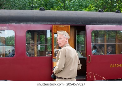 Sheringham, Norfolk, UK - SEPTEMBER 14 2019: Man In Military Officer Uniform Outside A Red Vintage Passenger Carriage