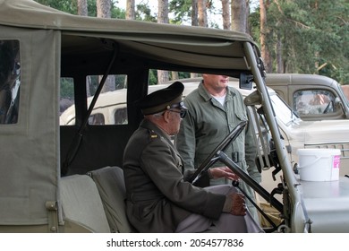 Sheringham, Norfolk, UK - SEPTEMBER 14 2019: Man In Military Officer Uniform Sits Behind The Wheel Of A 1941 Willys MB Military Jeep