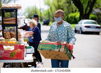 Sherman, TX / United States - April 1 2020: Members of the St John's Christian Methodist Episcopal Church in Sherman, TX, host a drive- up food pantry on April 1, 2020.