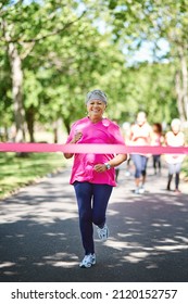 Shes The Big Winner. Shot Of A Senior Woman About To Win A Marathon.