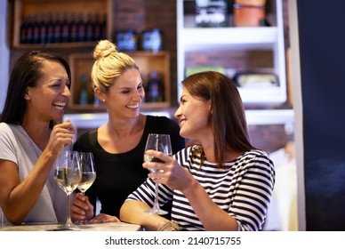 Shes A Bit Of A Wine Connoisseur. Cropped Shot Of Three Women Enjoying A Glass Of White Wine In A Restaurant.