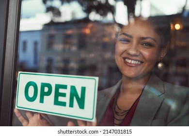 Shes Eager To Welcome All Her Customers. Portrait Of A Young Business Owner Hanging Up An Open Sign On The Window Of Her Cafe.