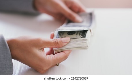 Shes earned this moola. Cropped shot of an unrecognizable businesswoman counting a stack of money in her office during the day.
