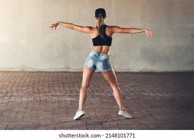 Shes Getting Her Groove Back. Rearview Shot Of A Female Street Dancer Practising Out In The City.