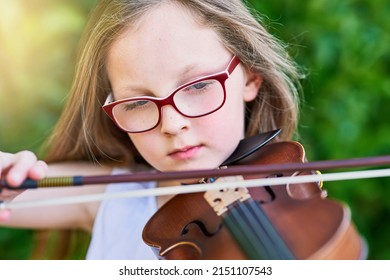 Shes Got Natural-born Musical Talent. Cropped Shot Of A Little Girl Playing The Violin Outside.