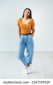 Shes Got Stye. Full Length Portrait Of An Attractive Young Woman Standing With Her Hands In Her Pockets In Studio.