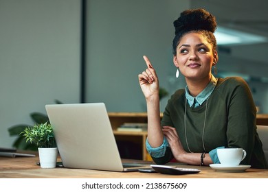 Shes Having One Of Those Lightbulb Moments. Shot Of An Attractive Young Woman Having A Lughtbulb Moment While Working On Her Laptop In The Office.