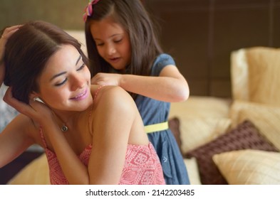 Shes So Helpful. Little Sister Helping Her Big Sister Get Dressed.