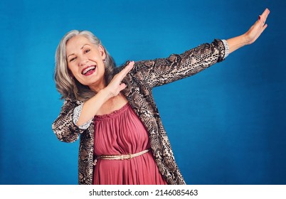 Shes Hitting The Dab. Portrait Of A Funky And Cheerful Senior Woman Dancing In Studio Against A Blue Background.