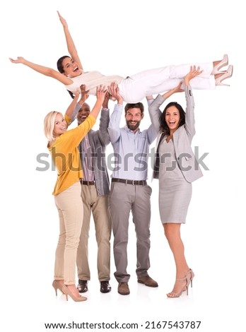 For shes a jolly good fellow-worker. Full length shot of a group of colleagues holding another coworker above their heads.