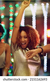 Shes Lights Up Any Party. Shot Of A Young Woman Having Fun On The Dance Floor.