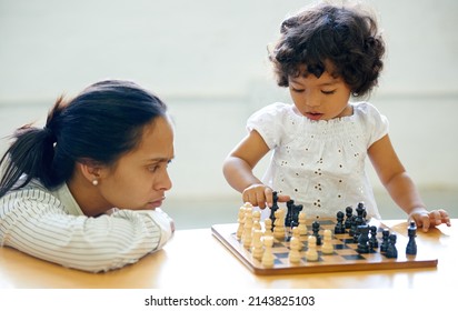 She's A Little Genius. A Little Girl Playing Chess.