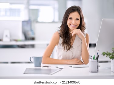 She's made it. Shot of an attractive businesswoman sitting at her desk in an office. - Shutterstock ID 2121400670