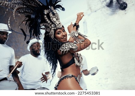 Shes a scintillating samba queen. Portrait of a beautiful samba dancer performing in a carnival with her band.