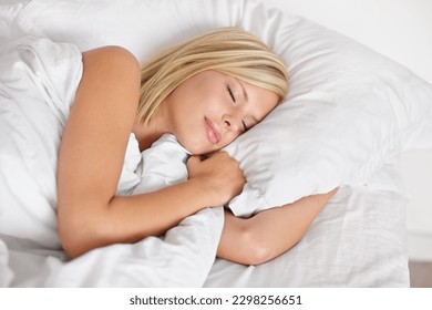 Shes sound asleep. A beautiful young woman sleeping in her bed.