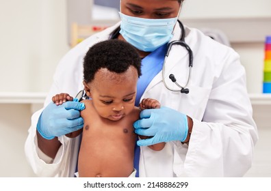 Shes a strong little one. Shot of a young female doctor doing a checkup on a baby at a clinic. - Shutterstock ID 2148886299