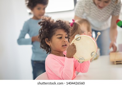 She's A Tambourine Girl. Child In Preschool.