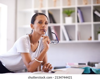 Shes Thinking Of Something Brand New. Shot Of An Attractive Seamstress At Work In Her Boutique.