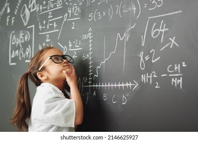 Shes way to clever for her age. Shot of an academically gifted young girl solving a math equation. - Shutterstock ID 2146625927