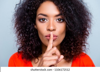 Shh! Closeup portrait of mysterious charming woman with modern hairdo asking for keeping silence holding forefinger on plump lips isolated on grey background - Powered by Shutterstock