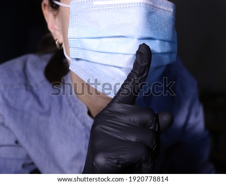 Shh! Keep your voice down! Shh sign. Face in mask. Keep secret. Don't speak. Information spreading prevention concept.