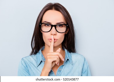 Shh! Pretty Woman In Glasses Showing Silent Gesture.