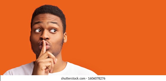 Shh, It's A Secret. Black Man Making Silence Gesture Putting Finger On His Lips Looking At Copy Space, Panorama