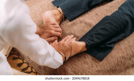 Shiatsu Foot Massage. Therapist Massaging The Kidney Meridian.