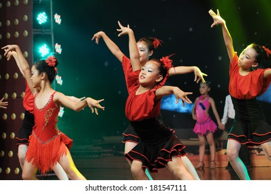 SHIJIAZHUANG CITY, CHINA - JULY 7: On July 7, 2012 In Shijiazhuang City, China Youth Arts Festival Unidentified Group Of Cute Kids Performing  Unrestrained Rumba Dance.