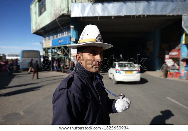 Shimla Himachal Pradesh India -\
February 05 2019 : Unidentified Indian police officer control the\
traffic at the street near by bus station in Shimla\
India