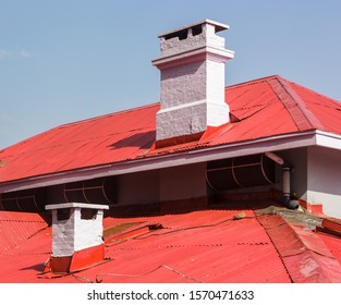 Shimla, Himachal Pradesh, India - May 2012: Small, Whitewashed Chimneys On The Red, Slanted Tin Roofs Of An Old Colonial Era House In The Hill Station.