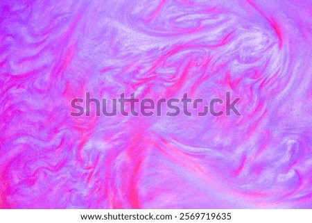 Shimmering multicolor abstract background. Liquid glitter paint texture waves and swirls. Beautiful shiny blue and pink glitter texture. Metallic paint close-up as a holiday background.