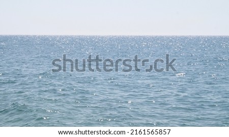 Shimmering seawater. Shimmering ocean background. Space for text. Beach background.