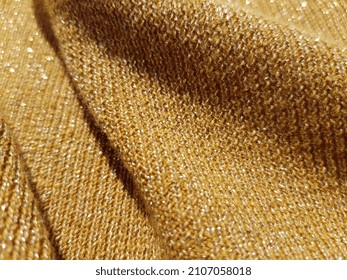 Shimmering Surface Of Mustard-colored Fabric With Lurex, In Diagonal Folds (macro, Knitted Elastic Band,
Texture).
