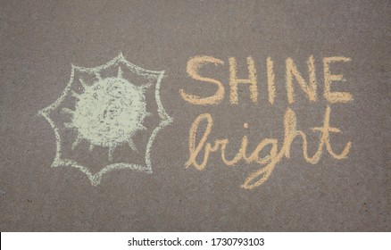 Shine Bright Written In Sidewalk Chalk With A Sun