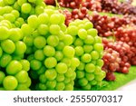 Shine Muscat grape, closeup, behind red grapes, sale on the shelf