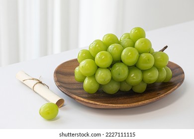 Shine Muscat grapes on a white background. White grapes.