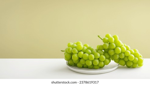 Shine Muscat, green grapes on a plate - Powered by Shutterstock