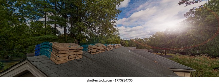 Shingle Bundles Stacked On Roof To Repair Storm Weather Damage	