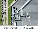 shingle roof of shopping mall with industrial air system of ventilation and air conditioning. aerial photo, top view.