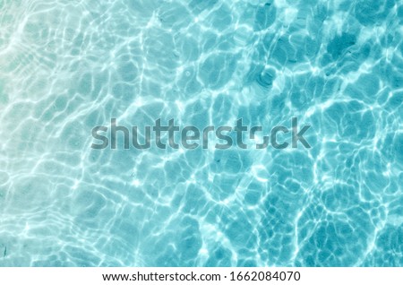 Shining blue water ripple background. Summer concept.
